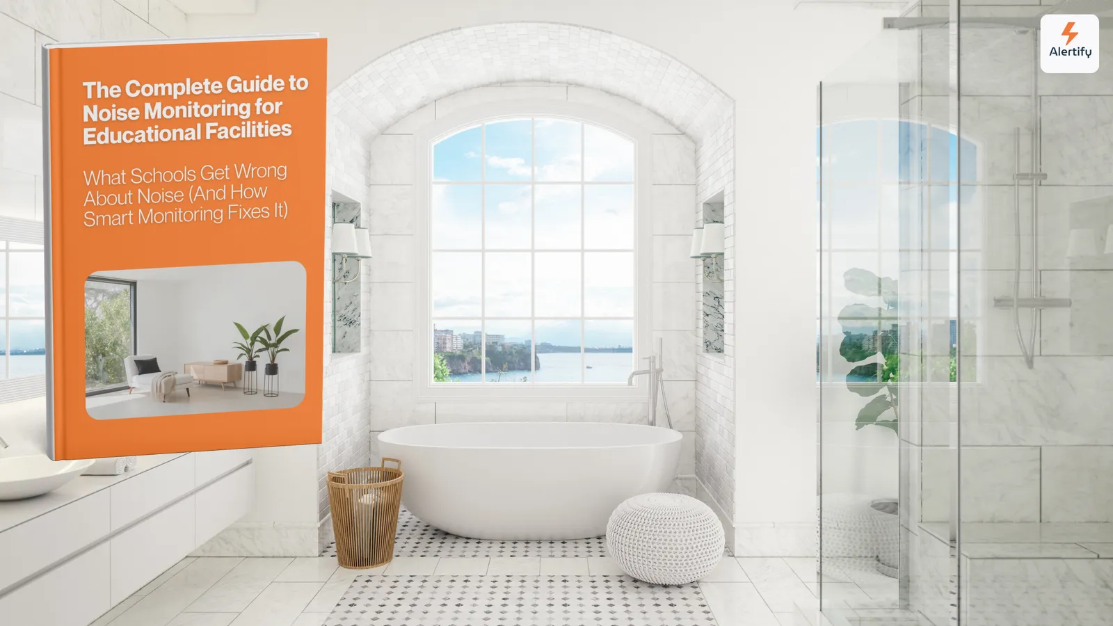 Un guide Alertify présenté comme un livre imprimé, posé sur le meuble-vasque d'une salle de bain lumineuse en marbre avec une baignoire îlot et vue sur mer.